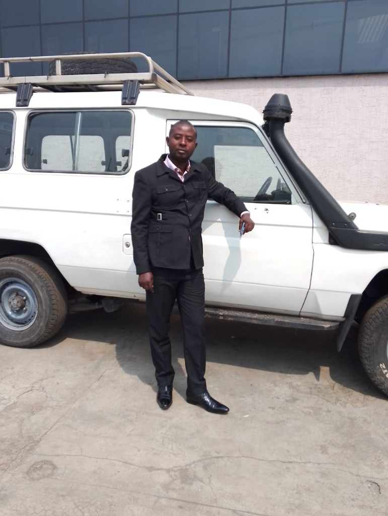 Me Habanabakize Daniel beside a training vehicle